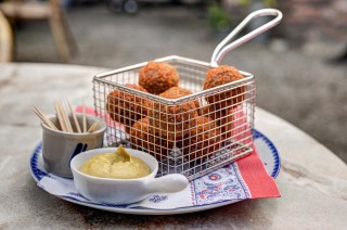 Bitterballen served with mostard on a table